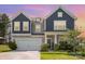 Charming two-story home with a well-manicured lawn and inviting front porch at 205 Falls Cove Dr, Troutman, NC 28166