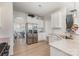 Spacious kitchen featuring stainless steel refrigerator, white cabinets and an eat-in area at 205 Falls Cove Dr, Troutman, NC 28166