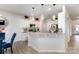 Open kitchen showcasing white cabinets, an island with bar seating, and pendant lighting at 205 Falls Cove Dr, Troutman, NC 28166