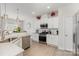 Well-lit kitchen with stainless steel appliances, white cabinets, and tile backsplash at 205 Falls Cove Dr, Troutman, NC 28166