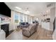Bright living room featuring a fireplace, large windows, and comfortable seating at 205 Falls Cove Dr, Troutman, NC 28166