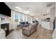 Bright living room featuring a fireplace, large windows, and comfortable seating at 205 Falls Cove Dr, Troutman, NC 28166