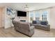 Bright living room featuring a fireplace, large windows, and comfortable seating at 205 Falls Cove Dr, Troutman, NC 28166
