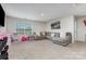 Spacious living room with carpet flooring, large window, and a sectional sofa at 205 Falls Cove Dr, Troutman, NC 28166