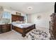 A spacious main bedroom is adorned with an ornate bed frame, neutral decor, and a light-filled window at 205 Falls Cove Dr, Troutman, NC 28166