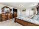 A secondary view of the main bedroom shows decoratively carved wooden furniture with a large television on a tall dresser at 205 Falls Cove Dr, Troutman, NC 28166