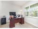 Office with a wooden desk, large window, and laminate wood flooring at 205 Falls Cove Dr, Troutman, NC 28166