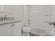 Bathroom with vanity, granite countertop, toilet, bathtub, and shower head at 207 Putnam St, Shelby, NC 28152