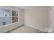 An empty bedroom has a large window providing plenty of light at 207 Putnam St, Shelby, NC 28152