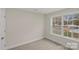 An empty bedroom has a large window providing plenty of light at 207 Putnam St, Shelby, NC 28152