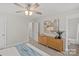 Calm bedroom with a blue throw blanket, natural decor and a chest of drawers at 207 Putnam St, Shelby, NC 28152