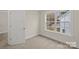 An empty bedroom has a large window providing plenty of light at 207 Putnam St, Shelby, NC 28152
