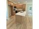Bright kitchen features an island with quartz countertops and modern appliances, with a white door visible in the background at 207 Putnam St, Shelby, NC 28152
