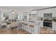 Well-lit kitchen featuring an island with barstool seating, stainless steel appliances, and white cabinetry at 207 Putnam St, Shelby, NC 28152