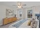 Bright main bedroom featuring two windows, a ceiling fan, and a wooden cabinet at 207 Putnam St, Shelby, NC 28152