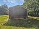 Exterior shot of the home showing the back yard, siding, and brick foundation at 232 Branchwood Cir, Kings Mountain, NC 28086