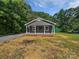 Charming home exterior featuring a welcoming front porch with white pillars and a well-manicured lawn at 232 Branchwood Cir, Kings Mountain, NC 28086