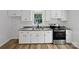 A modern kitchen with granite countertops, stainless steel appliances, and bright white cabinets at 232 Branchwood Cir, Kings Mountain, NC 28086