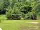 Backyard features wooden posts, trees, and lush greenery at 2350 Grubb Ferry Rd, Salisbury, NC 28144