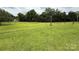 Expansive green backyard, trees, and overhead electrical lines at 2350 Grubb Ferry Rd, Salisbury, NC 28144
