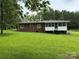 Brick home featuring a screened-in porch, green lawn, and backyard at 2350 Grubb Ferry Rd, Salisbury, NC 28144
