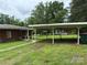 Side view of a brick home with a carport and a walkway leading to the house at 2350 Grubb Ferry Rd, Salisbury, NC 28144