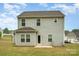 View of the house from the back featuring gray siding, a back door and green grass at 2507 Waverly Dr, Monroe, NC 28112