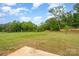 Expansive backyard featuring lush greenery and a patio area at 2507 Waverly Dr, Monroe, NC 28112