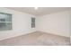 Bright, neutral bedroom featuring carpet flooring and two windows providing ample natural light at 2507 Waverly Dr, Monroe, NC 28112