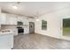 Bright, modern kitchen featuring white cabinets, stainless steel appliances, and a window view to the outdoors at 2507 Waverly Dr, Monroe, NC 28112