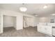 Spacious area featuring neutral walls, modern floors, and a view of the stairs and partial kitchen view at 2507 Waverly Dr, Monroe, NC 28112