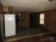 Living Room and partial kitchen with wood walls and worn carpet at 2927 S Nc 16 Hwy, Newton, NC 28658