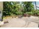 Expansive concrete patio with wooden railing overlooking the lush, green surroundings at 3307 Draper Ave, Charlotte, NC 28205