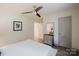 Spacious bedroom with wood-look floors, neutral walls, ceiling fan, and hall access at 3307 Draper Ave, Charlotte, NC 28205