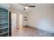 Bedroom with wood-look floors, closet, ensuite access, and a modern ceiling fan at 3307 Draper Ave, Charlotte, NC 28205