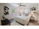 Bright bedroom with wood-look floors, neutral walls, stylish decor, and a ceiling fan at 3307 Draper Ave, Charlotte, NC 28205