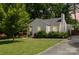 Charming single story home featuring a well-manicured lawn and lush trees providing shade and privacy at 3307 Draper Ave, Charlotte, NC 28205