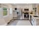 Contemporary kitchen with stainless steel appliances, white cabinetry, and a stylish backsplash for a modern aesthetic at 3307 Draper Ave, Charlotte, NC 28205