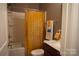 Cozy bathroom featuring a shower-tub combination with a yellow floral shower curtain at 4003 Northerly Island Ct, Gastonia, NC 28056