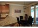 Breakfast nook features stylish light fixture, round glass table and access to outdoor patio at 4003 Northerly Island Ct, Gastonia, NC 28056