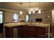 Open kitchen with granite counters, stainless appliances and island with view to living room at 4003 Northerly Island Ct, Gastonia, NC 28056