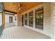 Outdoor porch with brick construction, stained ceiling, and a ceiling fan with peaceful views of nature at 4028 Spindrift Cove Dr # 59 And 60, Denver, NC 28037