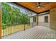 Spacious covered porch with wood ceiling, ceiling fan, and wooded views creates a relaxing outdoor space at 4028 Spindrift Cove Dr # 59 And 60, Denver, NC 28037