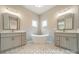 Spa-like bathroom with double sink vanities, a freestanding soaking tub, and elegant lighting fixtures at 4028 Spindrift Cove Dr # 59 And 60, Denver, NC 28037