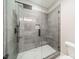Elegant tiled shower with a sleek design, black hardware, and a built-in niche at 4028 Spindrift Cove Dr # 59 And 60, Denver, NC 28037