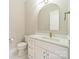 Elegant bathroom with white vanity, marble countertop, gold hardware, and a modern rounded mirror at 4028 Spindrift Cove Dr # 59 And 60, Denver, NC 28037