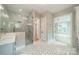 Contemporary bathroom featuring a glass-enclosed shower, stylish vanity, and patterned tile flooring at 4028 Spindrift Cove Dr # 59 And 60, Denver, NC 28037