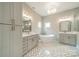 Luxurious bathroom with double vanities, a freestanding tub, modern fixtures, and decorative tile flooring at 4028 Spindrift Cove Dr # 59 And 60, Denver, NC 28037