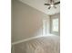 Bright bedroom features neutral walls, plush carpet, a ceiling fan, and natural light from the window at 4028 Spindrift Cove Dr # 59 And 60, Denver, NC 28037