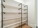 Custom closet shelving with industrial black pipe and white shelves; organized storage at 4028 Spindrift Cove Dr # 59 And 60, Denver, NC 28037